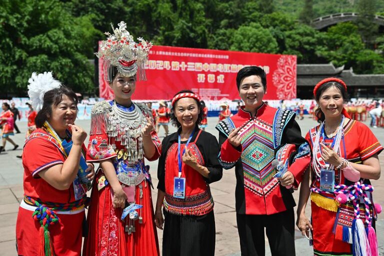5月15日，在重慶市彭水苗族土家族自治縣舉行的2024第十三屆中國烏江苗族踩花山節上，台灣少數民族代表（左一、中、右一）與苗鄉兒女合影。 中新社