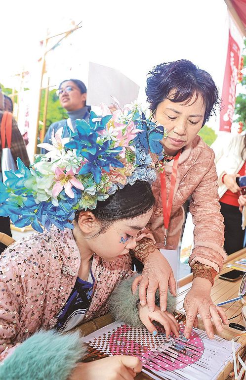 小朋友體驗永春紙織畫技藝。